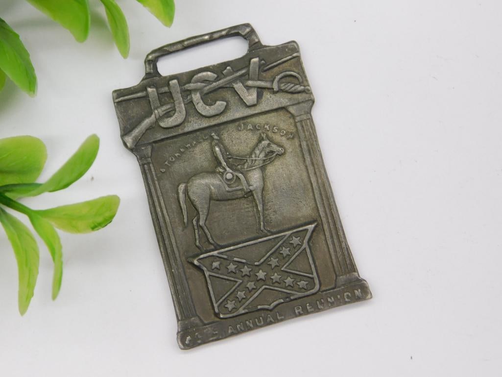 Sterling Silver UCV 6th Annual Reunion Watch Fob: Sterling silver watch fob marked 'STERLING' on the back. | - Features 'UCV' at the top with a design showing a rider on horseback and a Confederate flag. | - Engraved '6th Annual Reunion,' referencing