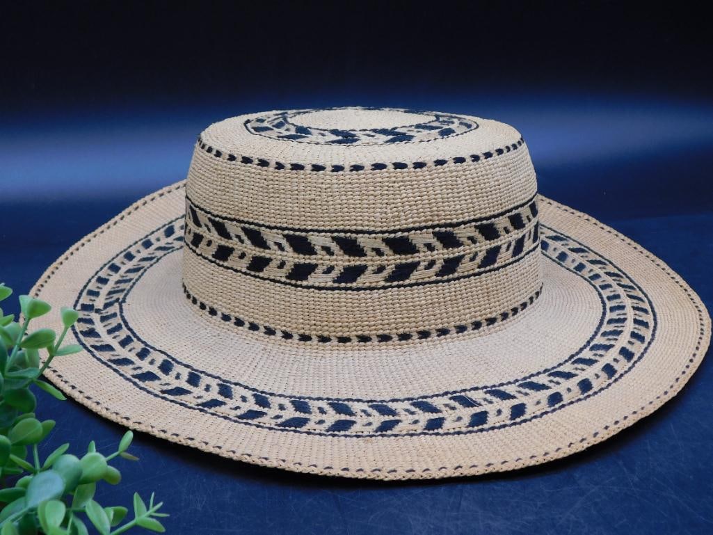Handwoven Straw Hat with Black Geometric Patterns: Material: Handwoven straw with detailed craftsmanship. | Design: Features black geometric patterns around the brim, crown, and top. | Dimensions: Proportional sizing indicated (refer to photos with ru