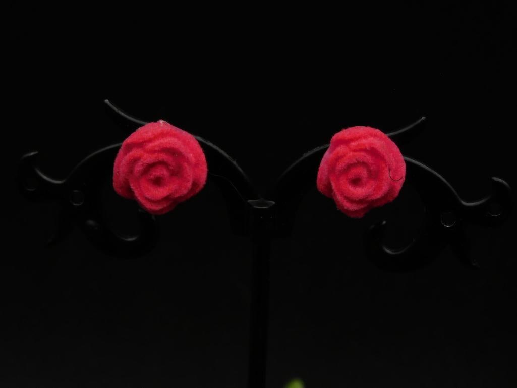 Red Rose Shaped Earrings: Features a pair of intricate red rose-shaped earrings. | Set on a black earring stand, ideal for display or gifting. | Earrings are lightweight and compact. | Stand not included, shown for photography