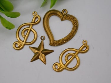 Four Gold-Toned Metal Charms in Various Shapes