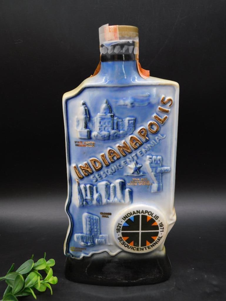 Indianapolis Bicentennial Commemorative Ceramic Bottle: - Ceramic bottle featuring a sculpted and painted depiction of Indianapolis landmarks | - Marked with "Indianapolis" and "Bicentennial 1821-1971" | - Front design includes landmarks and historical ima