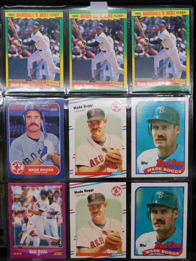 Wade Boggs Baseball Cards in Album Sheets: - Collection features a set of Wade Boggs baseball cards, displayed in clear album sheets. | - Cards include various styles and manufacturers, showcasing different designs and years. | - Each card hig
