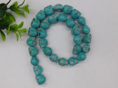 Strand of Blue Carved Skull Beads