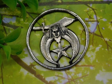 Metal Medallion with Sword, Crescent Moon, and Star Design