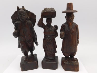 Three Hand-Carved Wood Figurines in Traditional Attire