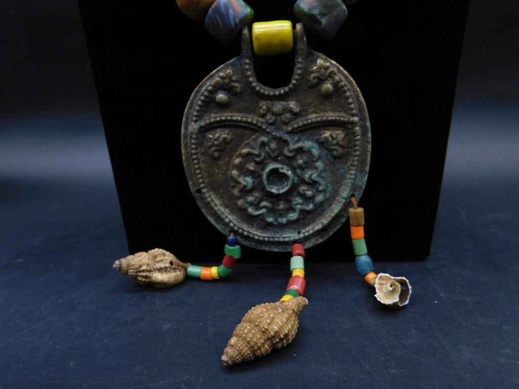 STAMPED METAL AND SHELL ACCENTED AFRICAN TRADE BEAD NECKLACE: STAMPED METAL AND SHELL ACCENTED AFRICAN TRADE BEAD NECKLACE
