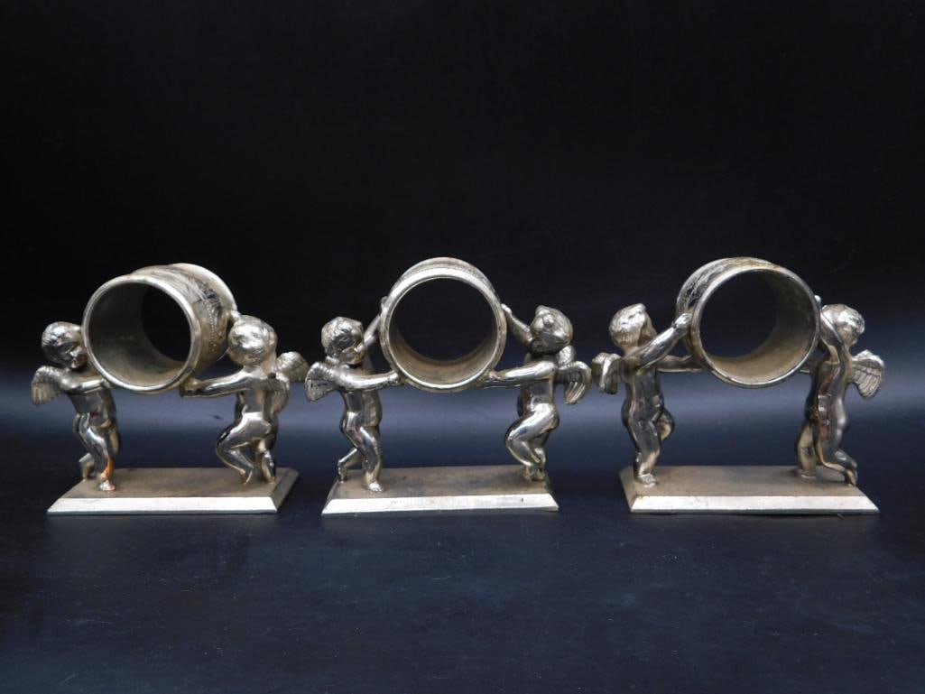 A VINTAGE FIGURAL NAPKIN RINGS FEATURING CHERUBS: VINTAGE FIGURAL NAPKIN RINGS FEATURING CHERUBS
