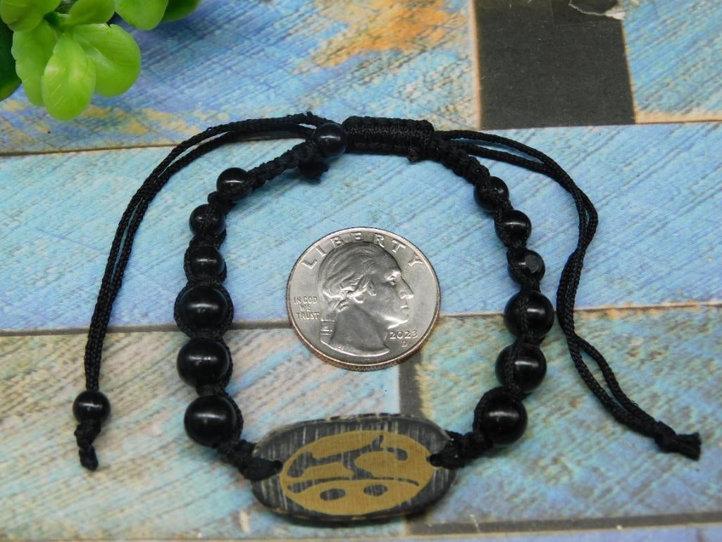 Black Corded Bracelet With Decorative Centerpiece: Black Corded Bracelet With Decorative Centerpiece