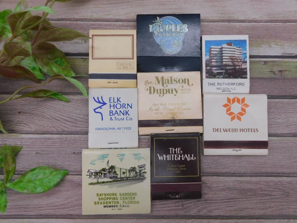 Collection of Seven Vintage Matchbooks: This is a grouping of seven matchbooks featuring promotional designs for various businesses and establishments. Includes matchbooks from locations such as Elk Horn Bank & Trust Co, The Maison Dupuy
