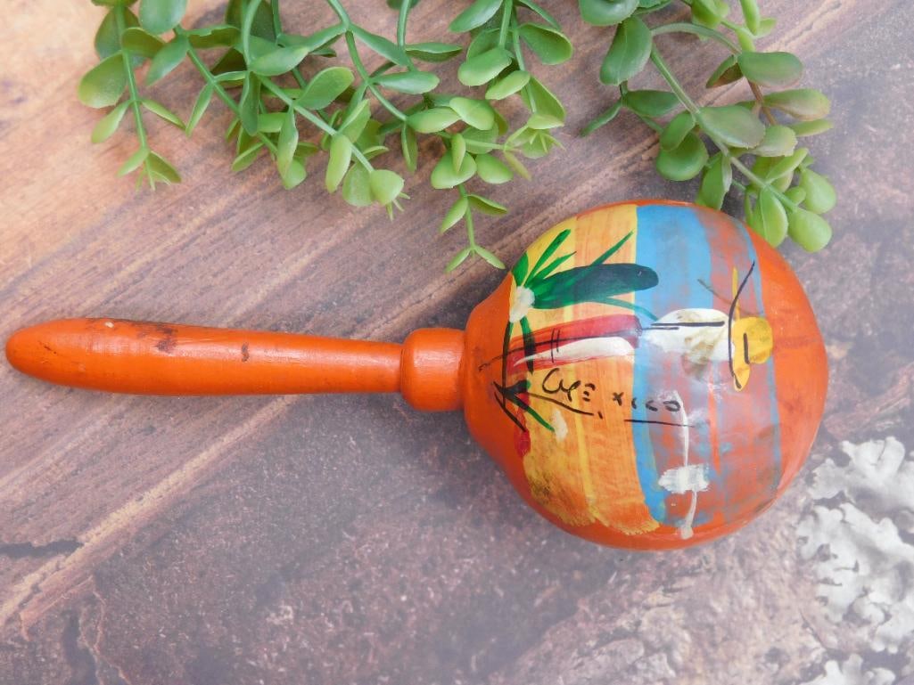 Hand-Painted Wooden Maraca With Colorful Abstract Design: - Hand-painted wooden maraca featuring an abstract, colorful design on the round head. | - Approximate length is specified by the included ruler for reference. | - Made of wood with a smooth
