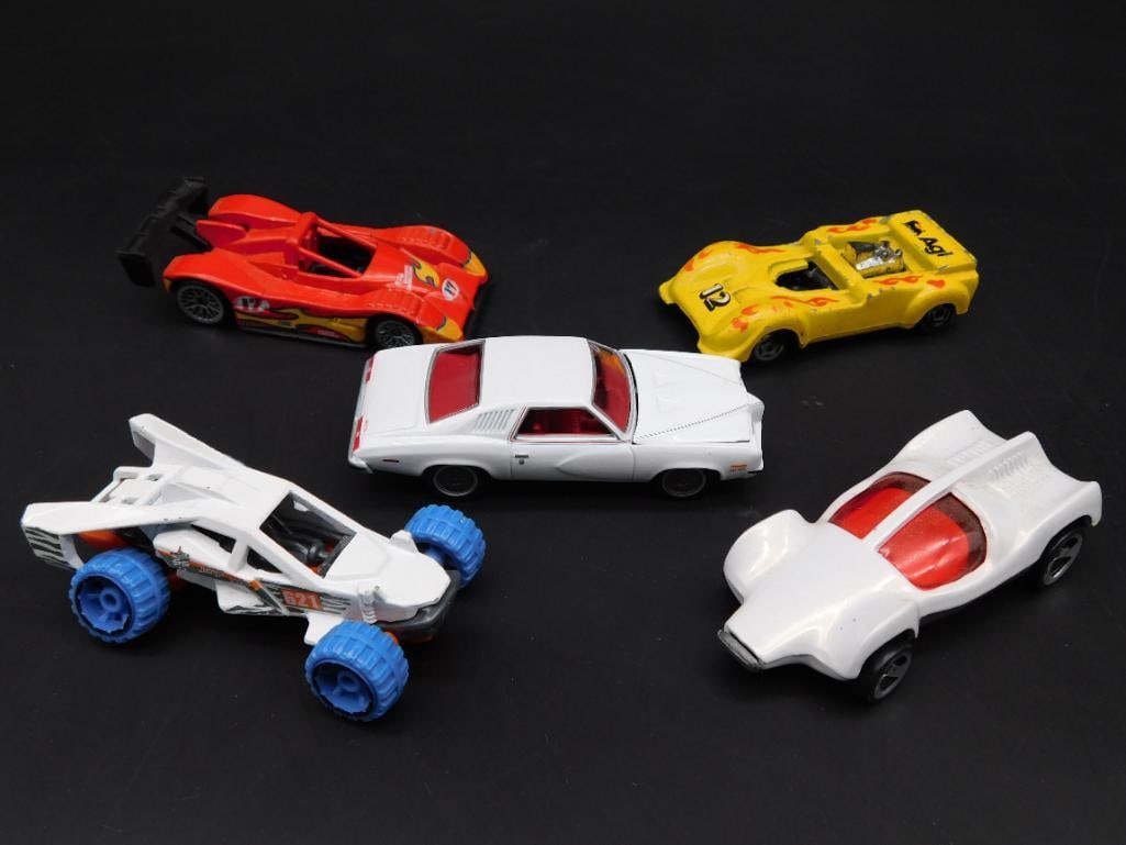 Hot Wheels Lot With Five Diecast Cars: This lot includes five diecast cars of various designs and years, manufactured by Mattel under the Hot Wheels brand. The models feature detailed undercarriage markings, showcasing car names and origin