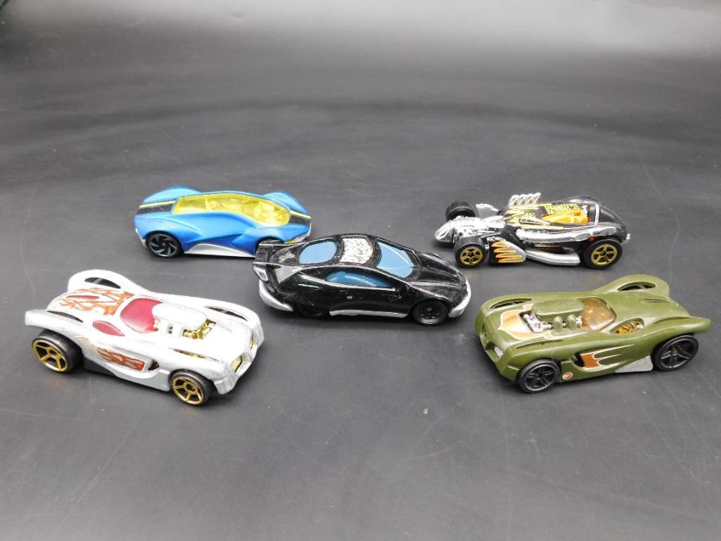 Lot of 5 Hot Wheels Diecast Cars, Various Models: This lot includes five diecast Hot Wheels cars from various years and models. The base markings indicate manufacturing dates ranging from 2003 to 2017, made in Malaysia and China. Models included are 