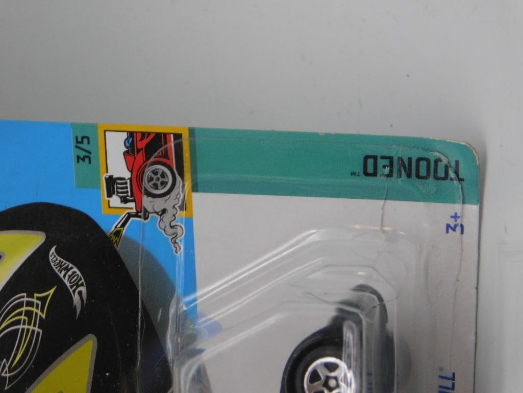 Hot Wheels Tooned Twin Mill Die-Cast Car, 3/5, 2003 Edition: Hot Wheels 'Tooned Twin Mill' die-cast car from the 2003 Tooned series (car number 3/5). The car features a black body with vibrant yellow detailing, chrome accents, and 5-spoke wheels. It remains in