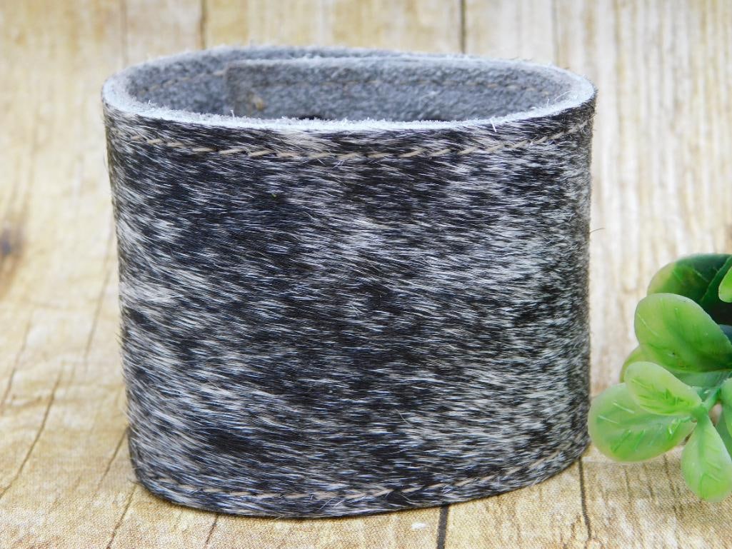 COW HIDE CUFF BRACELET: COW HIDE CUFF BRACELET - Part of our Discover Golden Attic, Crystals and Gems auction at HATMAN'S Auctions! Please see photos for measurements and condition. YES, we have in-house shipping! We have MA