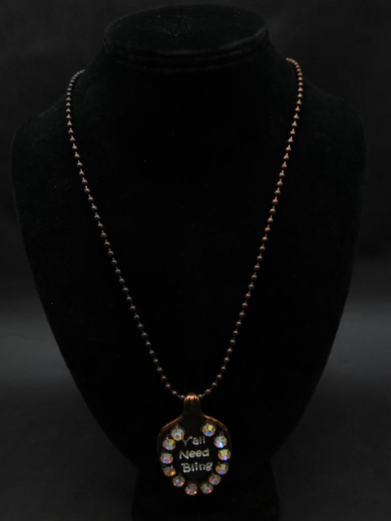 YALL NEED BLING SPOON NECKLACE: YALL NEED BLING SPOON NECKLACE - Part of our Discover Midnight Market, Crystals and Gems auction at HATMAN'S Auctions! Please see photos for measurements and condition. YES, we have in-house