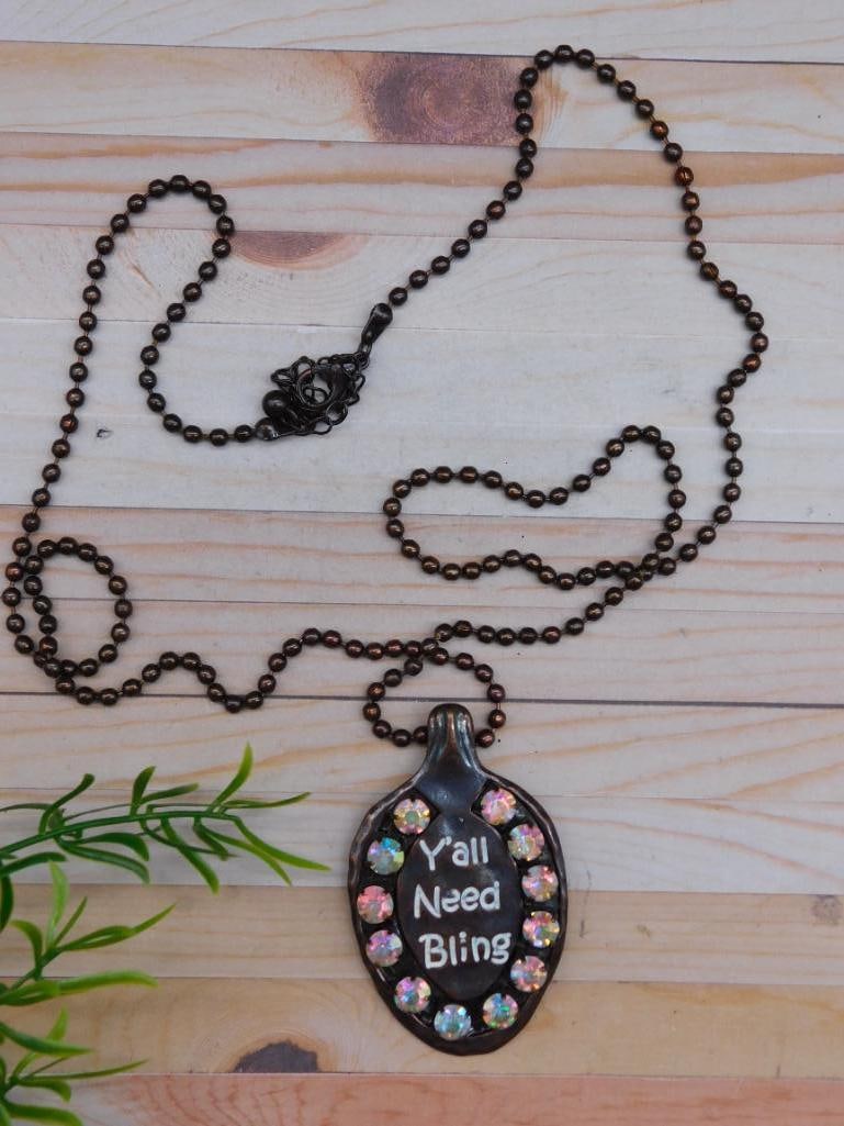 YALL NEED BLING SPOON NECKLACE: YALL NEED BLING SPOON NECKLACE - Part of our Discover Midnight Market, Crystals and Gems auction at HATMAN'S Auctions! Please see photos for measurements and condition. YES, we have in-house