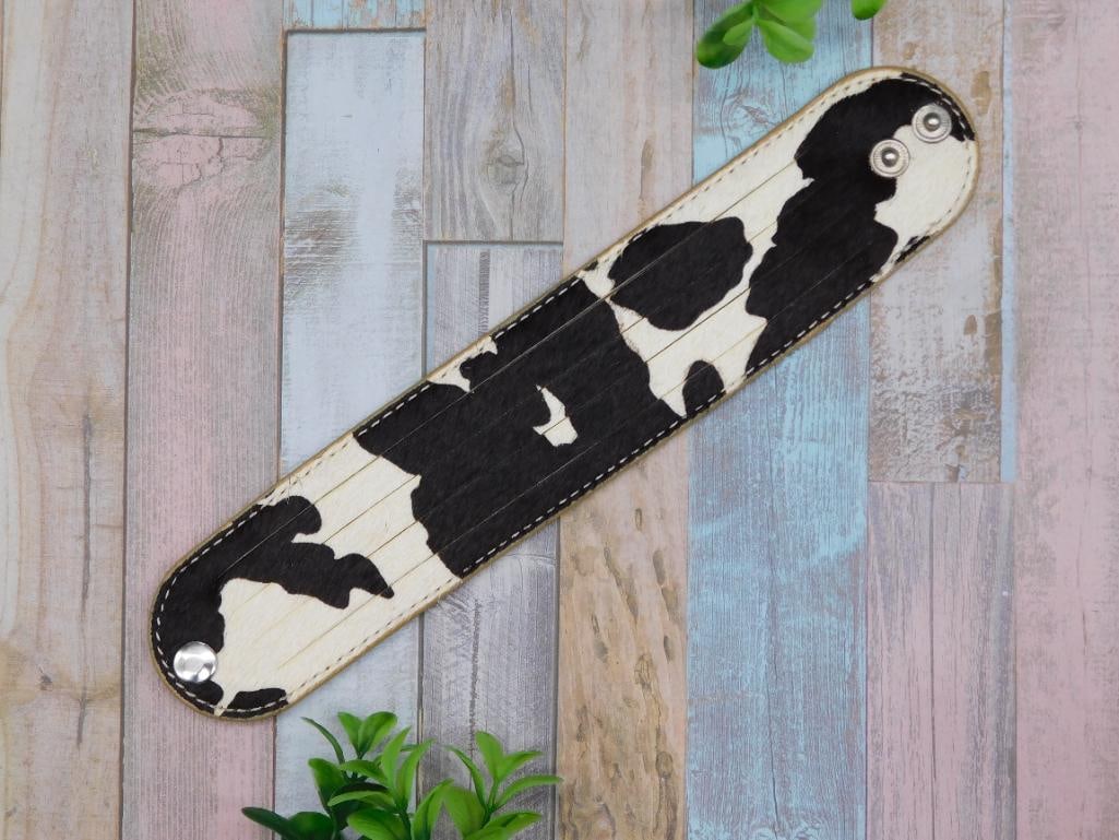 COW HIDE SNAP BRACELET: COW HIDE SNAP BRACELET - Part of our Discover Midnight Market, Crystals and Gems auction at HATMAN'S Auctions! Please see photos for measurements and condition. YES, we have in-house shipping! We have