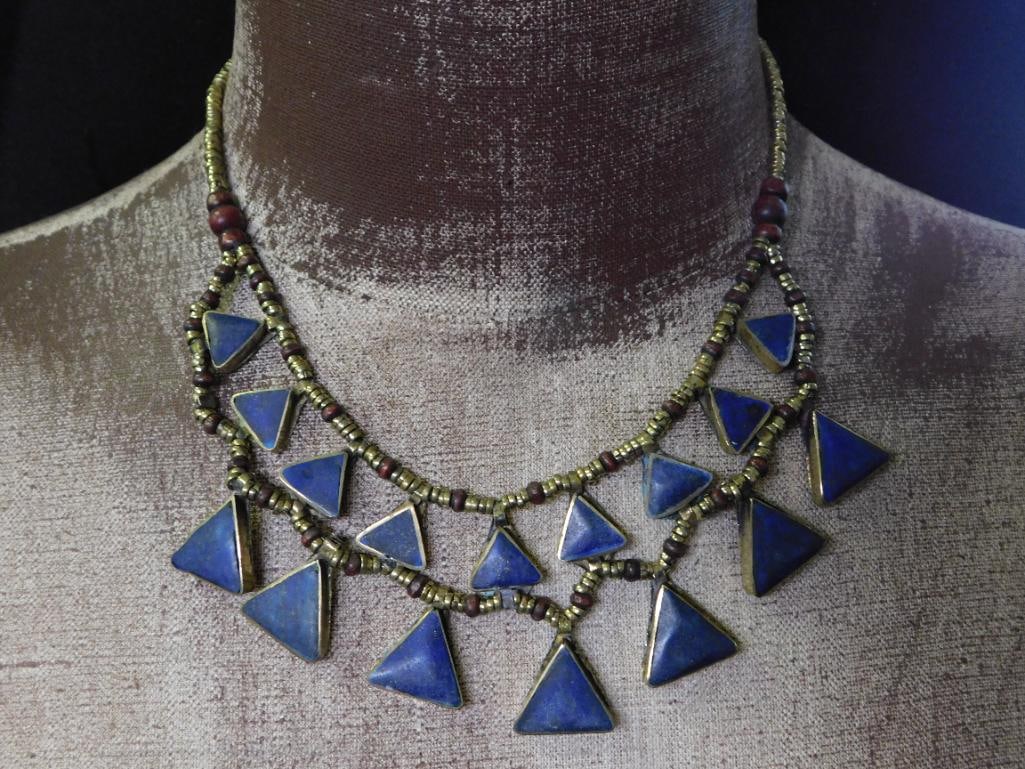 LAPIS LAZULI TRIANGLE NECKLACE ROCK STONE LAPIDARY SPECIMEN: LAPIS LAZULI TRIANGLE NECKLACE ROCK STONE LAPIDARY SPECIMEN — Part of our Discover Vintage Vault, Crystals and Gems auction at HATMAN'S Auctions! Please see photos for measurements and condition.