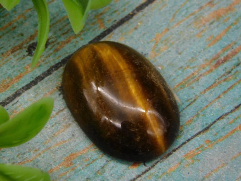 TIGER EYE CABOCHON: TIGER EYE CABOCHON — Part of our Discover Mystic Finds, Crystals and Gems auction at HATMAN'S Auctions! Please see photos for measurements and condition. YES, we have in-house shipping! We have