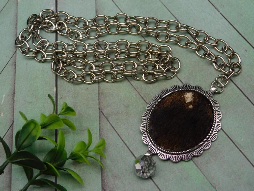 COW HIDE PENDANT ON CHAIN NECKLACE: COW HIDE PENDANT ON CHAIN NECKLACE - Authentic estate find offered in our online auction. Perfect for collectors, resellers, and enthusiasts of vintage, antiques, minerals, rocks, crystals, jewelry, a