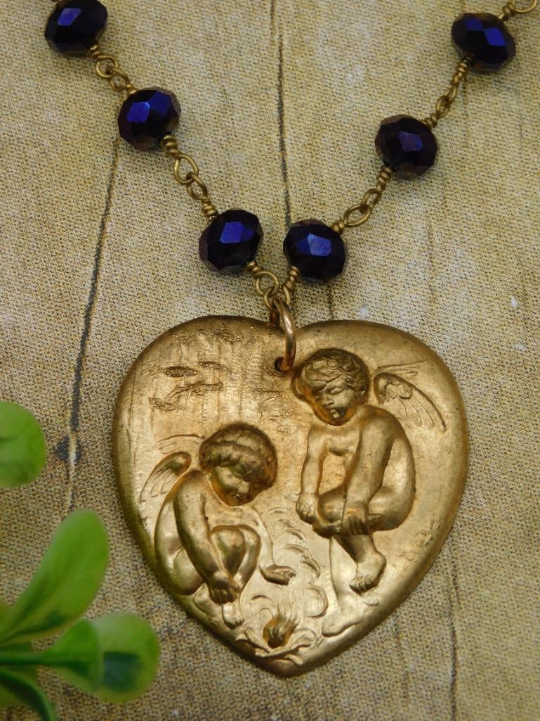 CHERUB HEART PENDANT ON BEADED NECKLACE: CHERUB HEART PENDANT ON BEADED NECKLACE - Authentic estate find offered in our online auction. Perfect for collectors, resellers, and enthusiasts of vintage, antiques, minerals, rocks, crystals, jewel