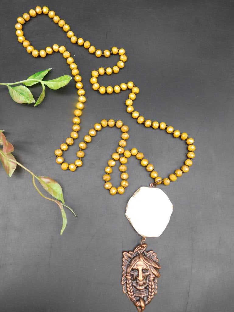 Beaded Necklace With Pendant and Octagonal Stone Accent: Beaded Necklace With Pendant and Octagonal Stone Accent - This necklace features yellow beads strung together, accented by a large octagonal-shaped white stone with subtle veining. Attached is a detai