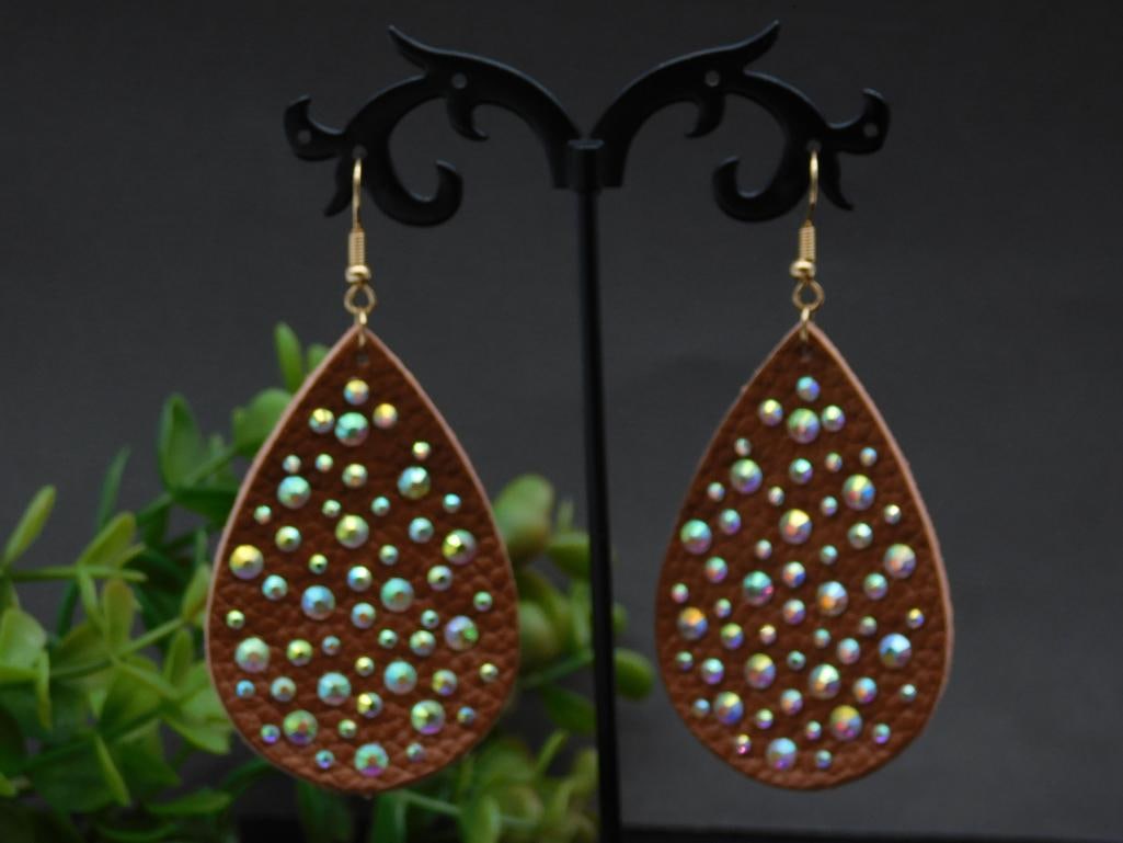 Teardrop Faux Leather Earrings with Rhinestone Accents: Teardrop Faux Leather Earrings with Rhinestone Accents - - Teardrop-shaped earrings made of soft faux leather material. | - Embellished with iridescent rhinestones creating a shimmering effect. | - Fe