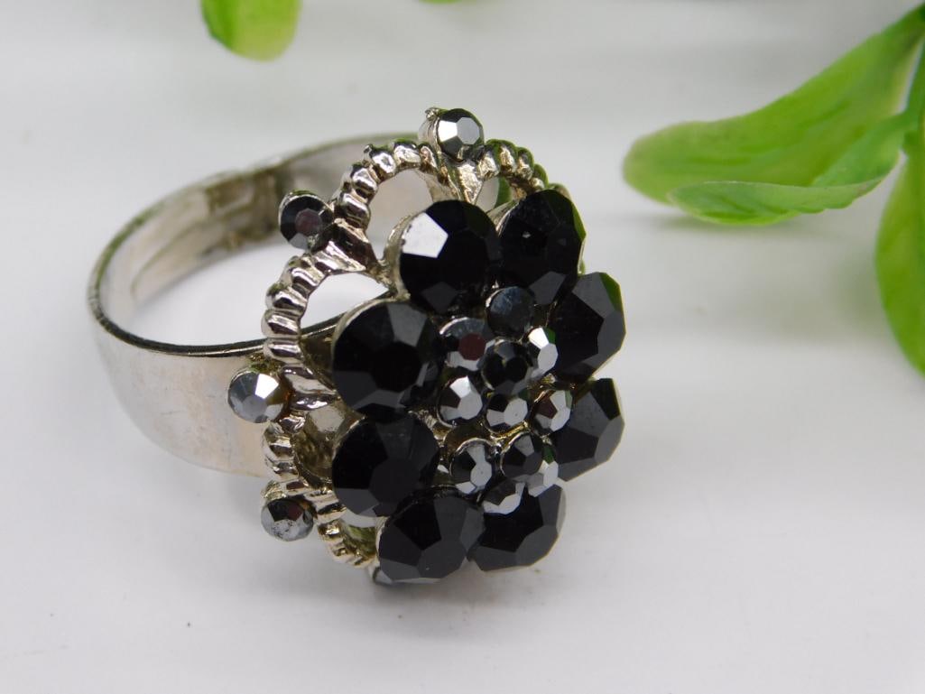 Silver-Tone Black Floral Adjustable Ring: Silver-Tone Black Floral Adjustable Ring - Part of our Discover Gilded Gallery, Crystals and Gems auction at HATMAN'S Auctions! Please see photos for measurements and condition. YES, we have in-house 