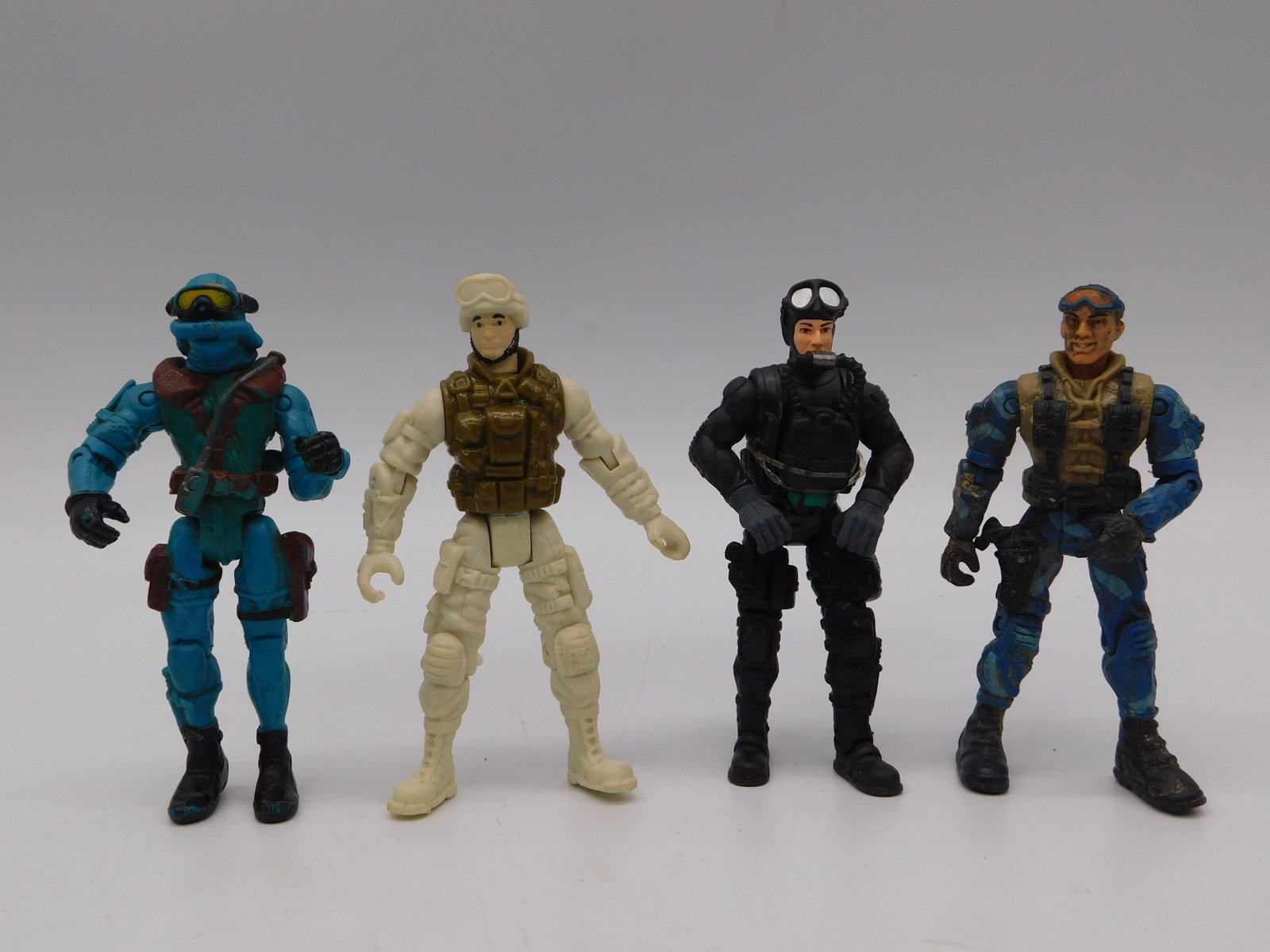 Vintage Tactical Military Action Figures Lot Four Piece Collectible Set: Vintage Tactical Military Action Figures Lot Four Piece Collectible Set featuring four uniquely detailed articulated figures depicting military personnel in specialized tactical gear. This compelling 