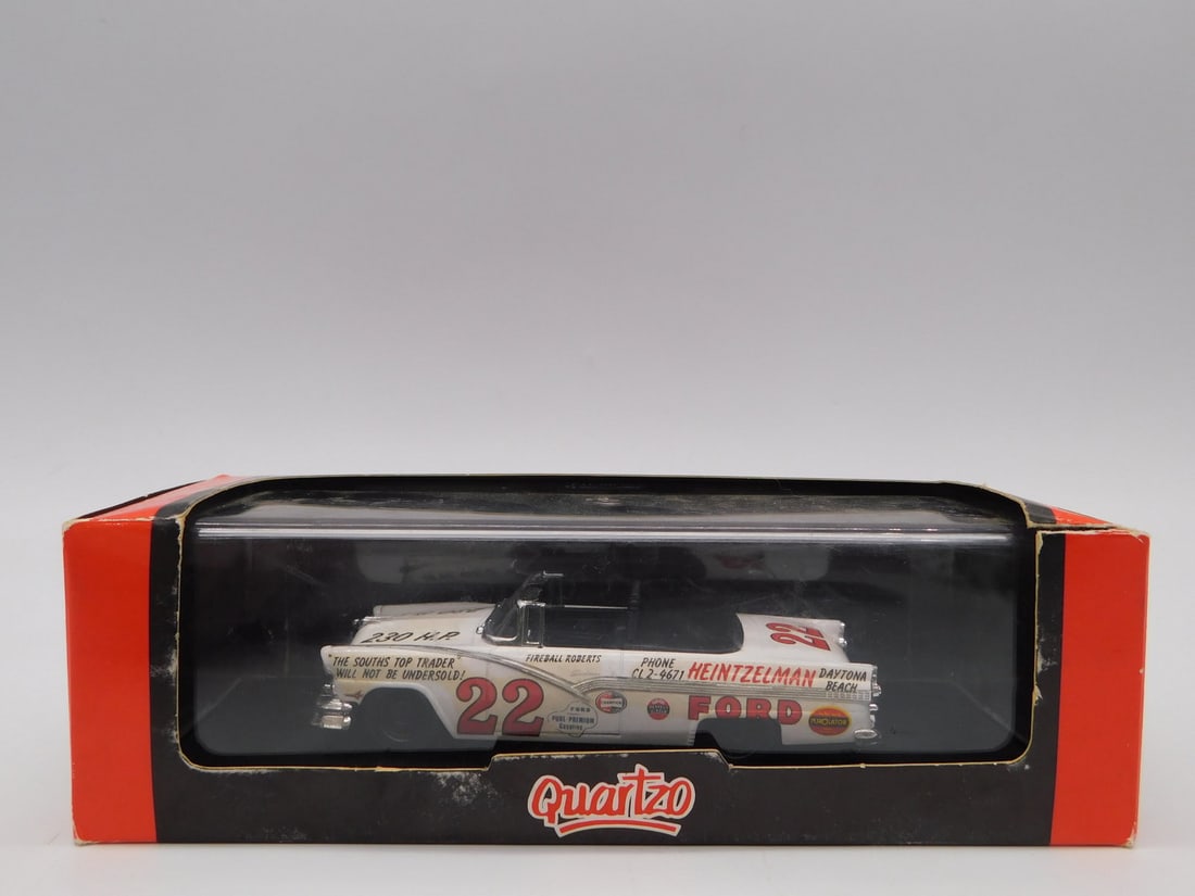 Quartzo 1/43 Scale Diecast Stock Car #22 Fireball Roberts Ford in Display Case: A 1/43 scale diecast model of a vintage white and red #22 Ford stock car, lettered for driver Fireball Roberts and sponsor Heintzelman Ford of Daytona Beach, with period-style advertising graphics inc