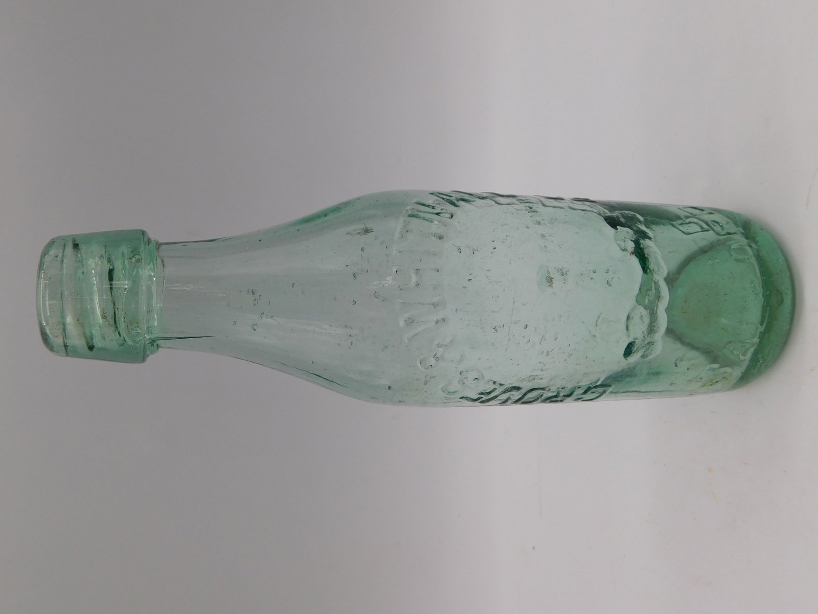 Vintage Antique Aqua Glass Bottle BLOB TOP Embossed Maker Mark Pontil Collectible: Vintage Antique Aqua Glass Bottle Embossed Maker Mark Pontil Collectible represents a genuine period piece from the late 19th or early 20th century. This sea green to aqua-toned bottle exhibits authen