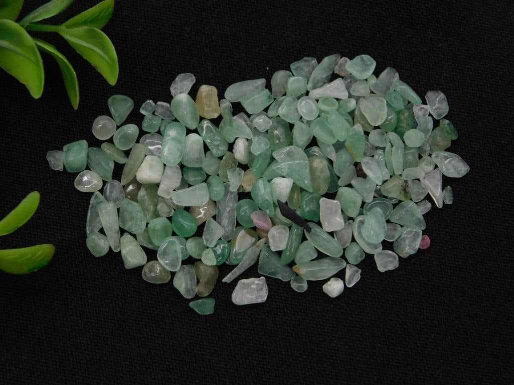 Green Aventurine Tumbled Stone Chips, 12 Grams: A small lot of green aventurine stone chips, labeled and weighed at 12 grams. Nice for jewelry making or a small mineral collection. Natural stone with typical color variation throughout.