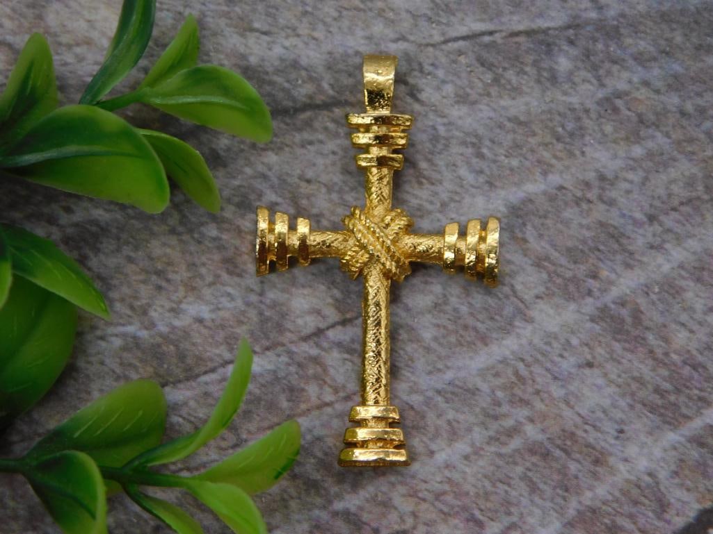 Gold-Tone Cross Pendant - Textured Vintage Jewelry Cross: A gold-tone cross pendant with a textured, woven center design and ribbed detailing along each arm. The pendant measures approximately 2 inches long. A classic piece that would pair nicely with any