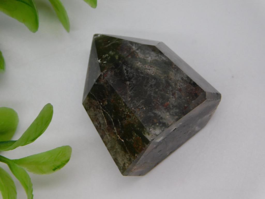 Faceted Dark Crystal Point, 16 Grams: A dark faceted crystal point with a pointed geometric top, weighing 16 grams per the lot tag. Measures approximately 1.5 inches tall. A nice small addition for a crystal collection or display.