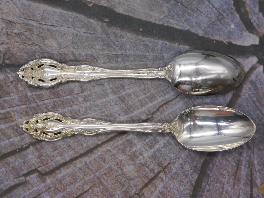 Sterling Silver — Pair of Gorham Sterling Tablespoons, Approx. 6 Inches: This lot presents a matched pair of sterling silver tablespoons stamped "Gorham Sterling," each approximately 6 inches in length. The spoons share an oval bowl and a decorative scrolled handle with an