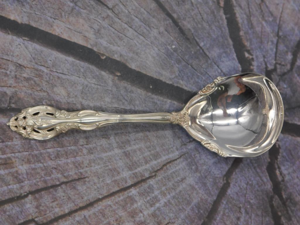 Sterling Silver Cream Ladle — Gorham Pattern, 6.75 Inches: A sterling silver cream or gravy ladle with a round bowl, marked Gorham Sterling in the same ornate pattern used elsewhere in this collection. It measures approximately 6.75 inches long.