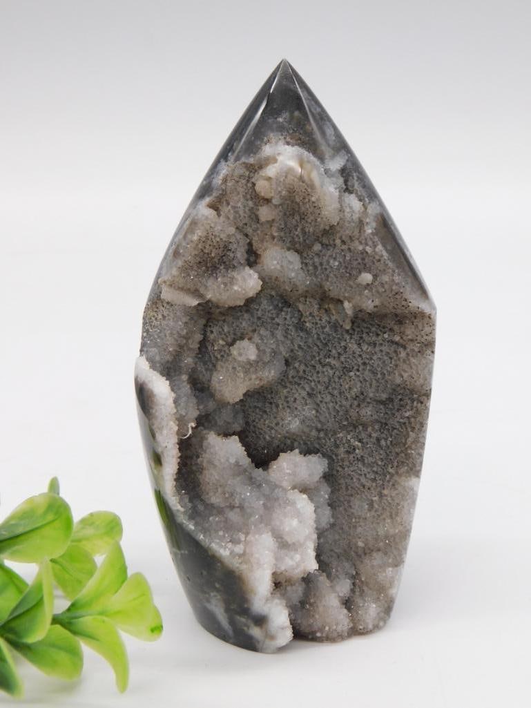 Polished Agate Point Crystal: A tall polished agate/geode point with a druzy quartz crystal pocket exposed on one side, dark gray banding with white crystalline inclusions. 232 grams.