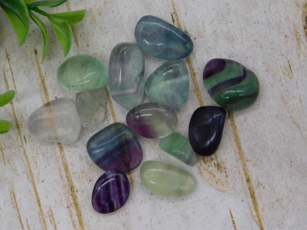 Fluorite Tumbled Stone Lot: Assorted rainbow fluorite tumbled gemstones in purple, green, and blue hues.