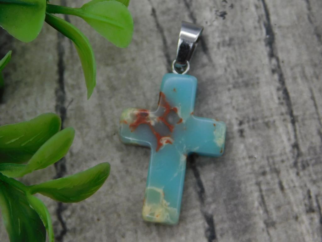 Blue Agate Cross Pendant: Carved blue agate cross pendant with rust-red inclusions and silver-tone bail.
