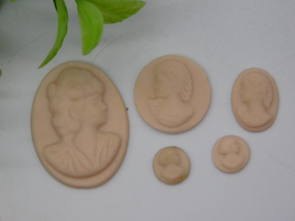 Lot of 5 Loose Carved Cameo Cabochons, Assorted Sizes: Five unset carved cameo cabochons in a soft flesh/resin tone, each depicting a Victorian-style lady in profile. Sizes range from a large oval (approx. 1.5 inches) down to two small round cameos under 