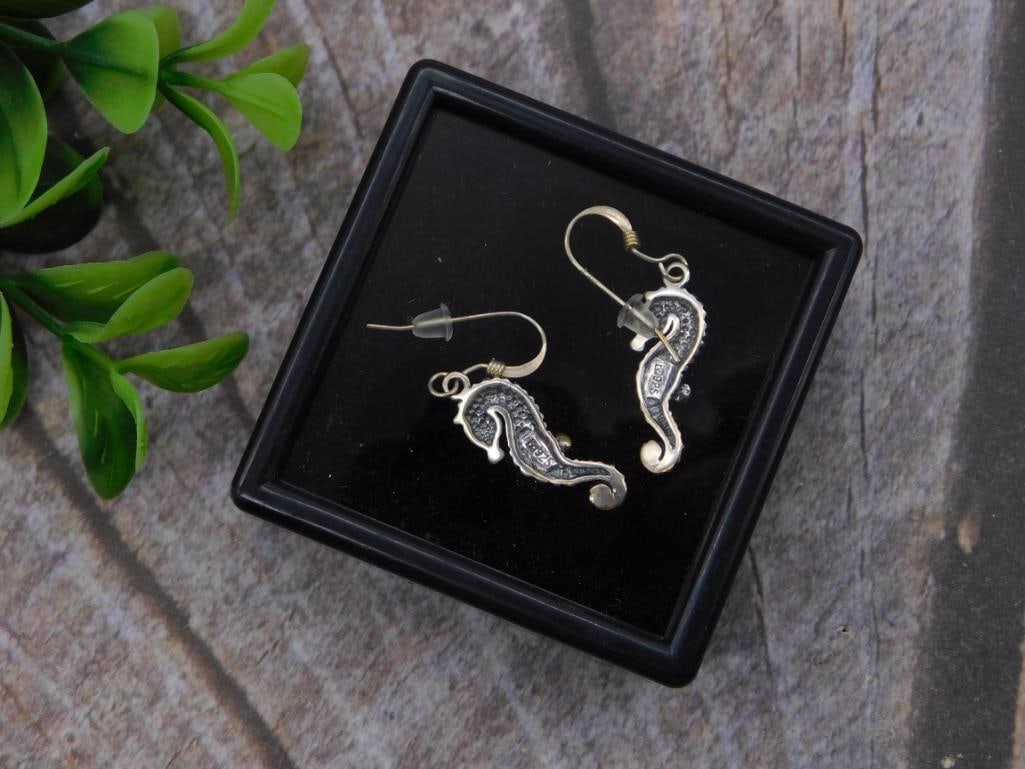 Sterling Silver Seahorse Dangle Earrings: A pair of sterling silver seahorse-shaped dangle earrings with fishhook wire backs, displayed in a small presentation box. Each seahorse charm measures approximately 1 inch long, shown next to a