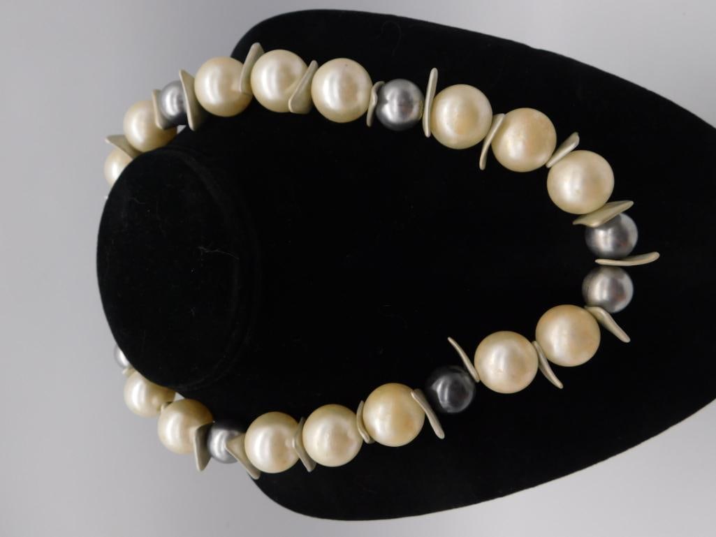 Faux Pearl Beaded Statement Necklace with Silver Spacers: A chunky beaded necklace featuring large cream faux pearls interspersed with gray/black pearl accents and curved silver-tone spacer beads. Measures approximately 18-20 inches in circumference per the 