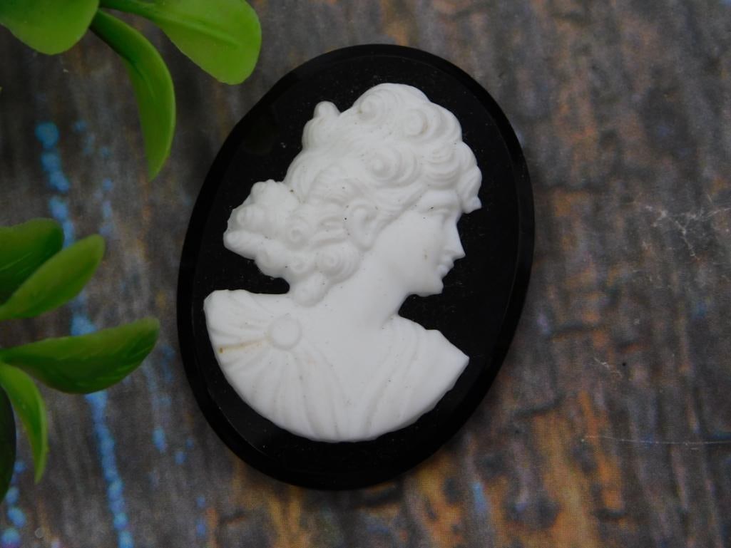 Victorian Style Cameo Pendant, Black & White Lady Portrait: Carved cameo depicting a Victorian lady in profile, white relief figure set against a glossy black oval ground. Approximately 1.5 inches tall (roughly quarter-sized), unmounted/loose cameo suitable