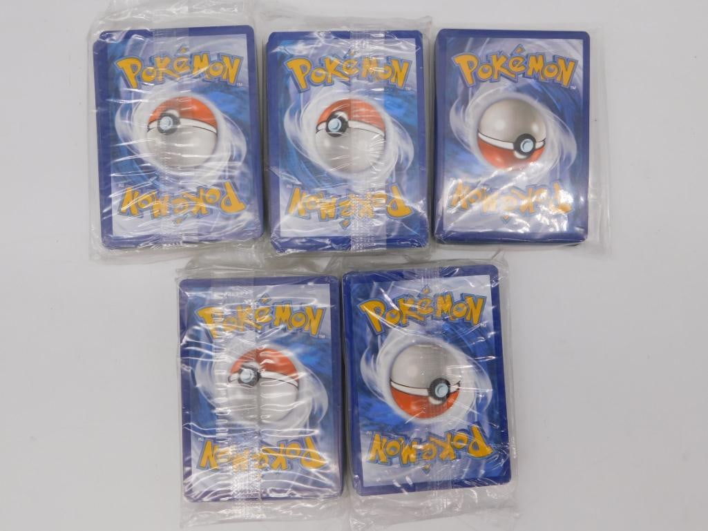 Pokemon Trading Card Game Sealed Card Lot, 5 Decks: Five sealed/wrapped stacks of Pokemon trading cards still in their original plastic sleeves, each showing the classic Poke Ball card-back design. Sold as a group; contents unopened and unverified by