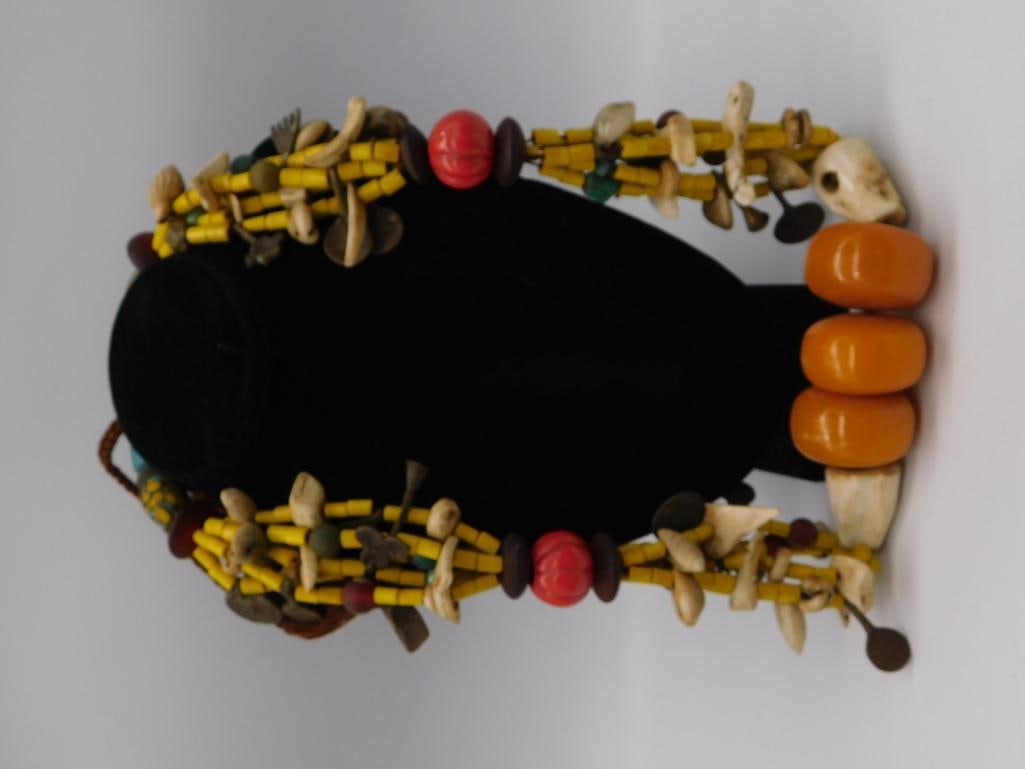African Trade Bead Necklace, Amber Resin Bone & Shell: Multi-strand ethnic trade bead necklace featuring large amber-colored resin barrel beads, carved bone and shell pendants, cowrie shells, and yellow tubular beads. Measures approximately 22-24 inches