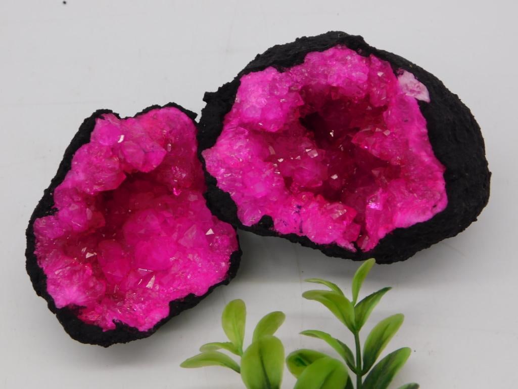 Pink Cobalt Calcite Crystal Geode Pair: Matched pair of vivid pink cobalt calcite geode halves with sparkling druzy crystal centers set in dark matrix rock. Each measures approximately 4-5 inches across. Striking natural mineral display