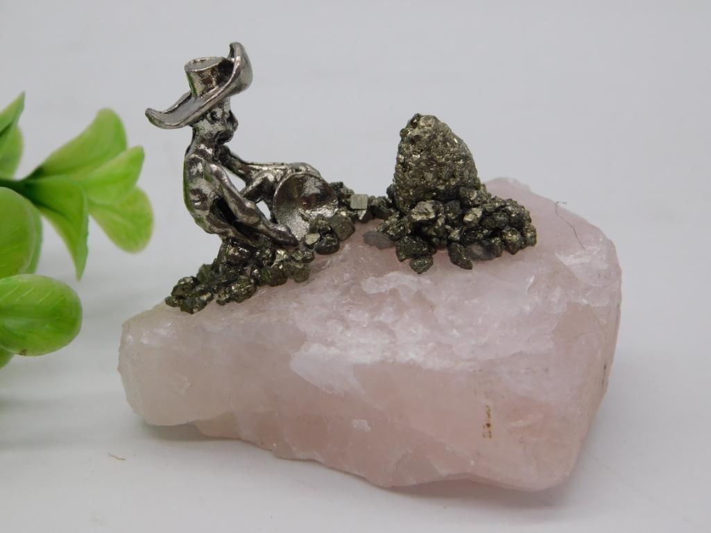 Pyrite on Rose Quartz with Pewter Prospector Figurine, 88g: Natural rose quartz base topped with sparkling pyrite crystal clusters and a miniature pewter prospector figurine panning for gold. Decorative mineral display piece weighing 88 grams.