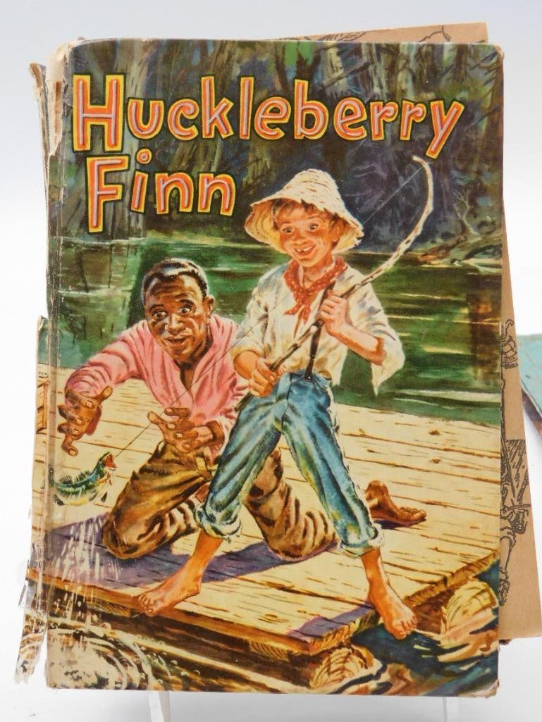 Vintage Huckleberry Finn Book: Whitman Publishing hardcover edition of The Adventures of Huckleberry Finn with a colorful illustrated cover of Huck and Jim fishing on a raft. Cover shows significant wear, torn edges, and a partiall