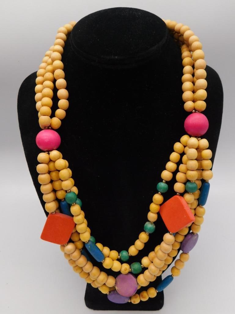 Multi-Strand Wood Bead Necklace: A layered statement necklace made of natural tan wood beads with accent beads in pink, orange, blue, green, and purple.