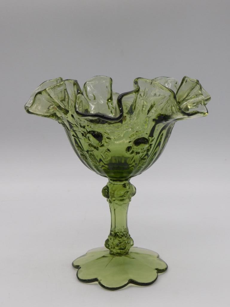 Green Depression Glass Ruffled Compote: A green pressed glass compote with a ruffled, crimped rim and scalloped footed base, standing approximately 6-7 inches tall.